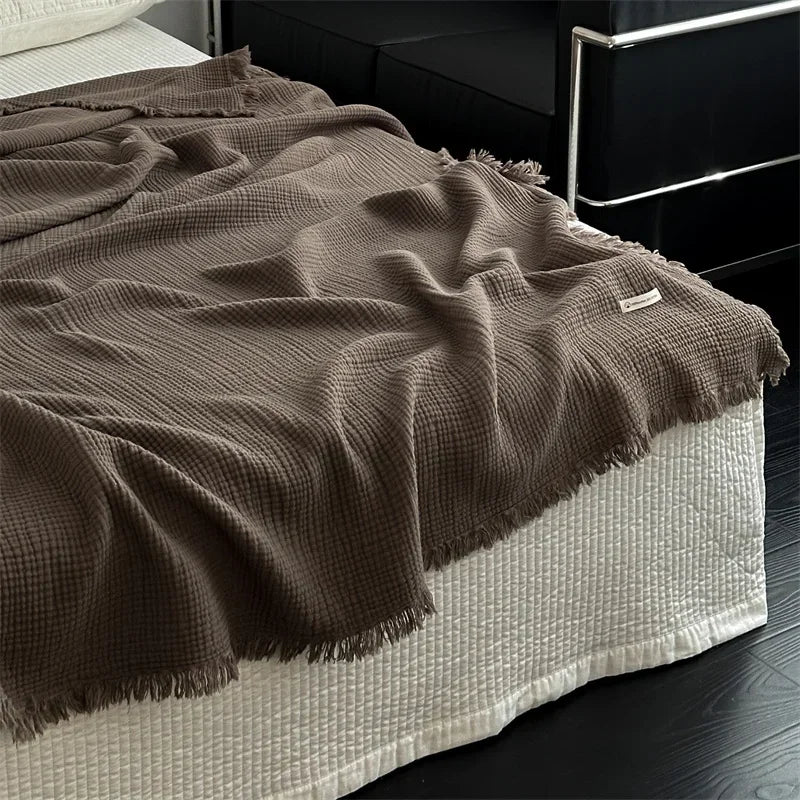 1pc Blanket 100% Cotton Sofa Towel Tassels Bed Linen Solid Color Shawl manta Skin-friendly Plaid Home Blankets draped on a sofa.