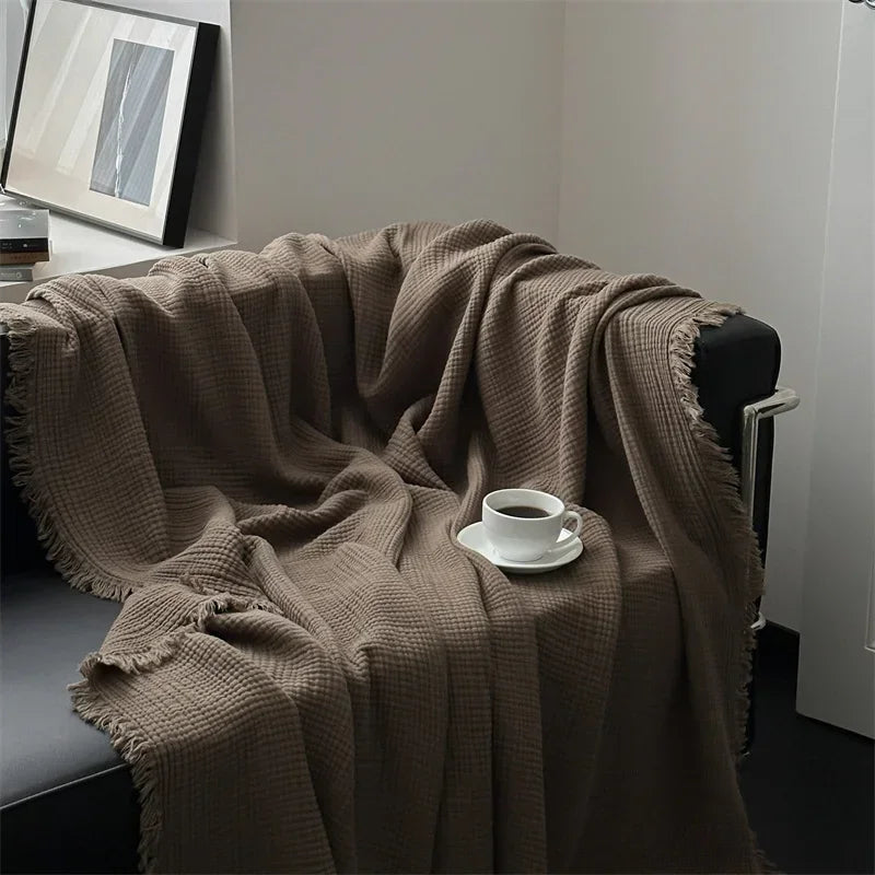 1pc Blanket 100% Cotton Sofa Towel Tassels Bed Linen Solid Color Shawl manta Skin-friendly Plaid Home Blankets draped on a sofa.
