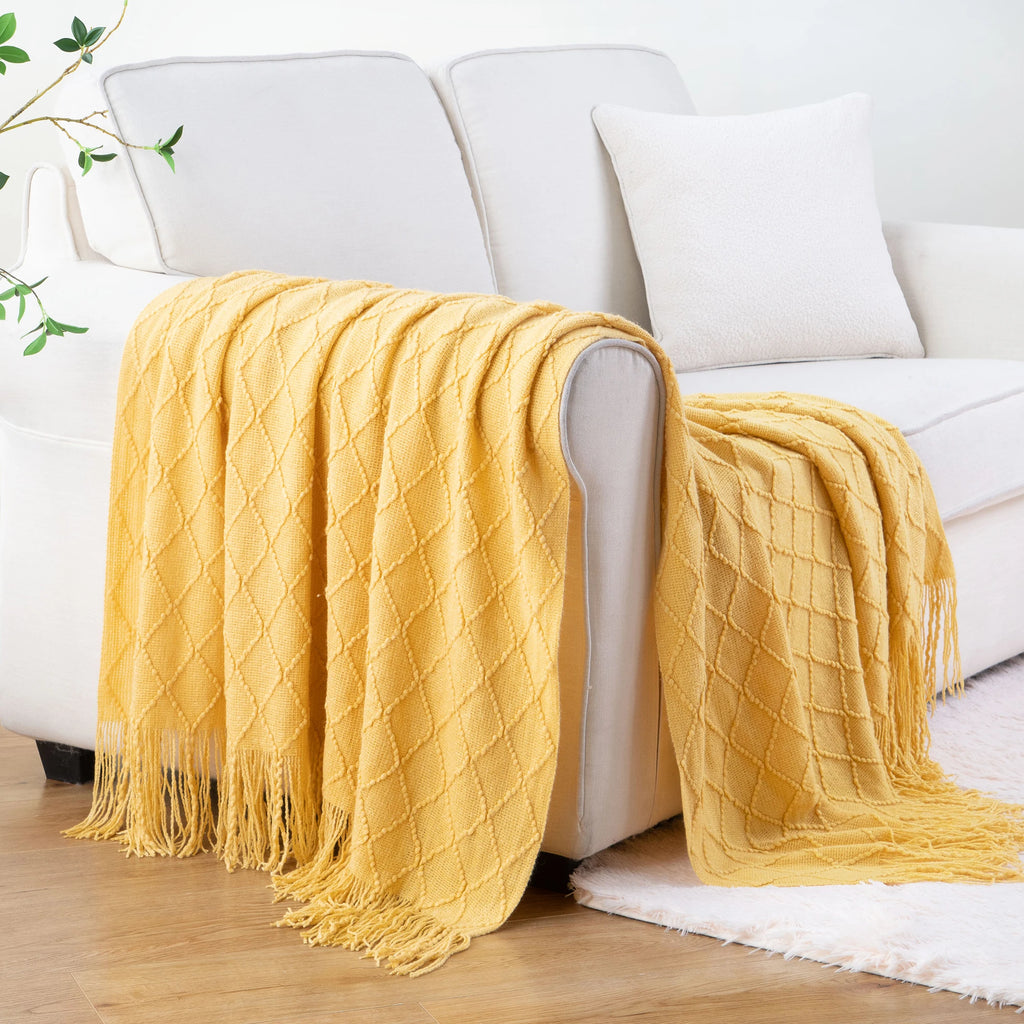 Battilo Plaid Knitted Throw Blanket Soft Woven Throws Sofa Blanket draped over a sofa arm.
