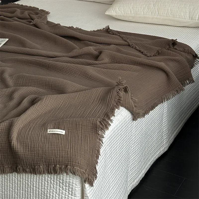 1pc Blanket 100% Cotton Sofa Towel Tassels Bed Linen Solid Color Shawl manta Skin-friendly Plaid Home Blankets draped on a sofa.