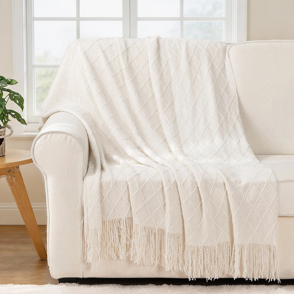 Battilo Plaid Knitted Throw Blanket Soft Woven Throws Sofa Blanket draped over a sofa arm.