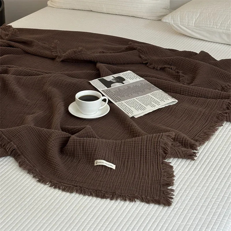 1pc Blanket 100% Cotton Sofa Towel Tassels Bed Linen Solid Color Shawl manta Skin-friendly Plaid Home Blankets draped on a sofa.
