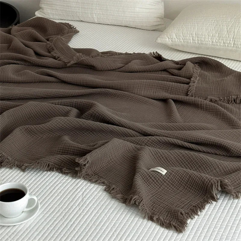 1pc Blanket 100% Cotton Sofa Towel Tassels Bed Linen Solid Color Shawl manta Skin-friendly Plaid Home Blankets draped on a sofa.