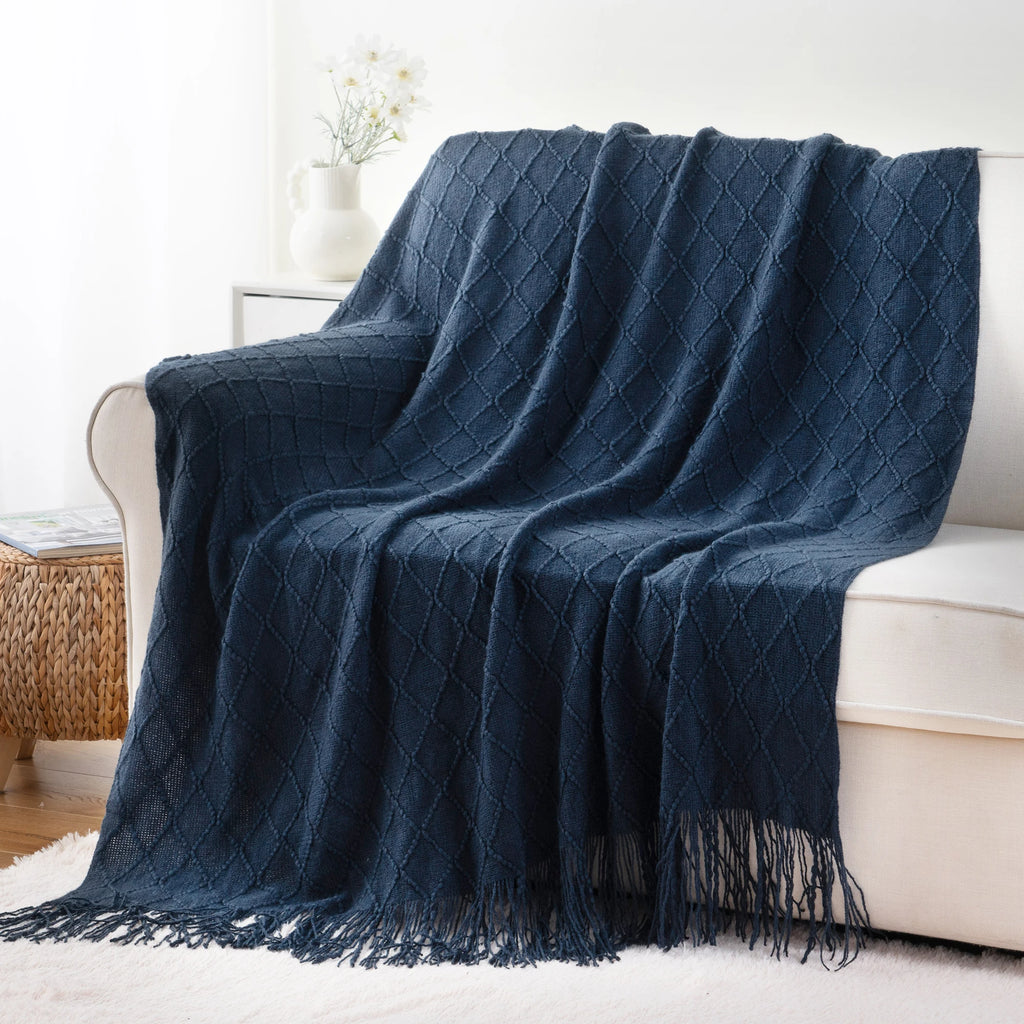 Battilo Plaid Knitted Throw Blanket Soft Woven Throws Sofa Blanket draped over a sofa arm.