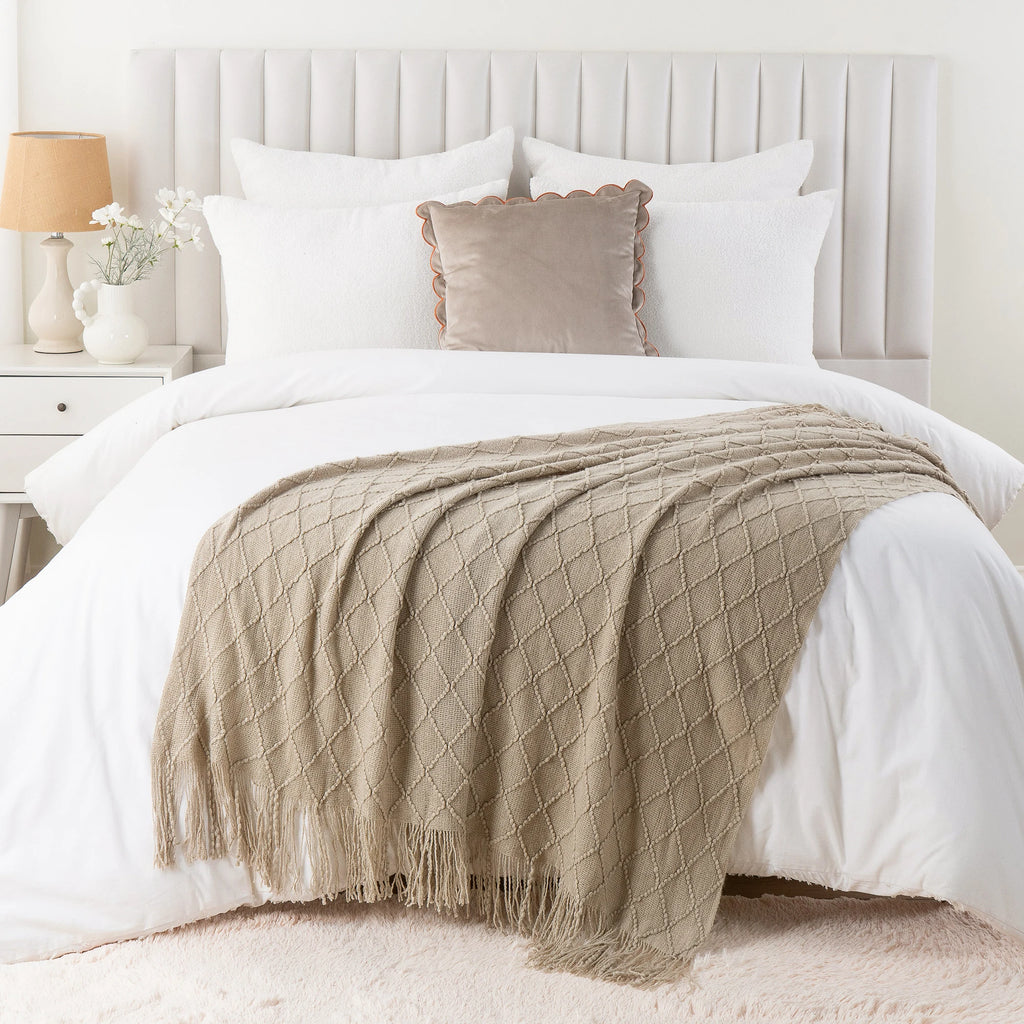 Battilo Plaid Knitted Throw Blanket Soft Woven Throws Sofa Blanket draped over a sofa arm.