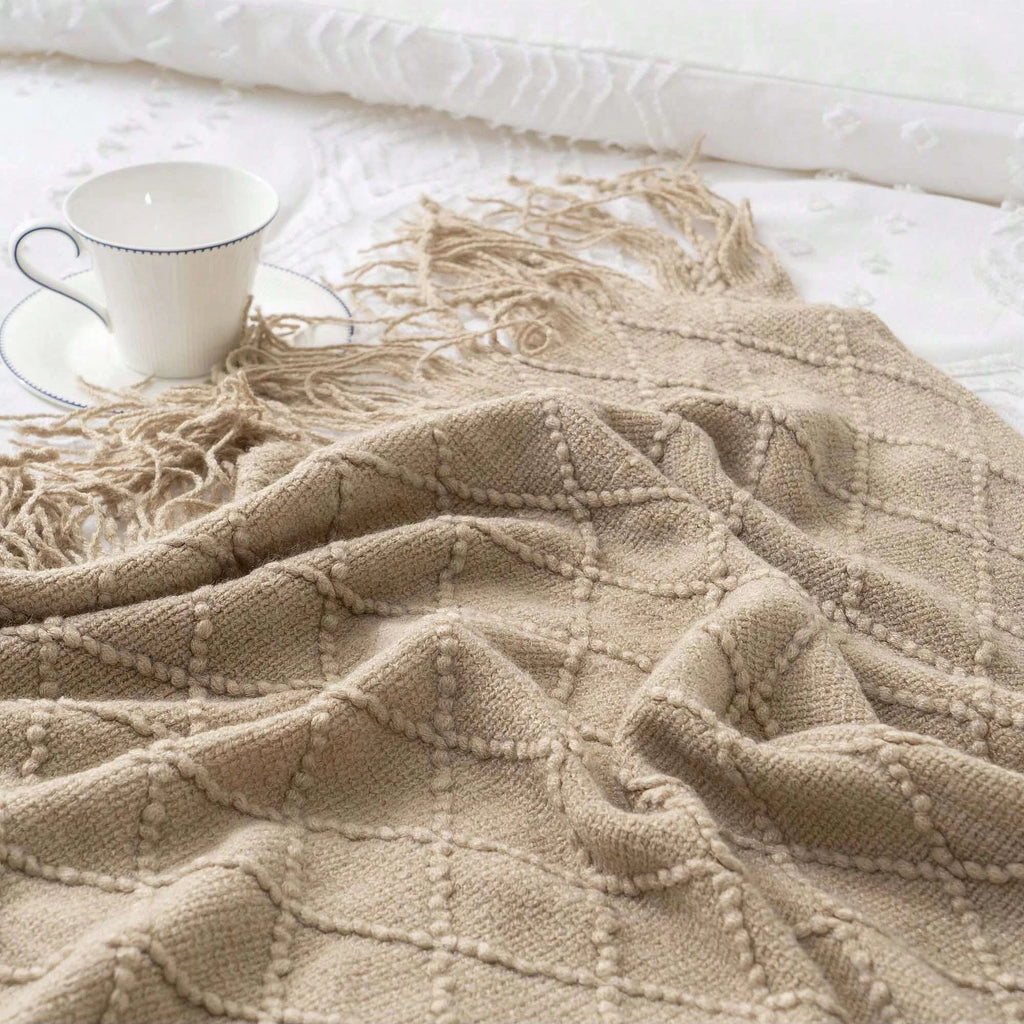 Battilo Plaid Knitted Throw Blanket Soft Woven Throws Sofa Blanket draped over a sofa arm.