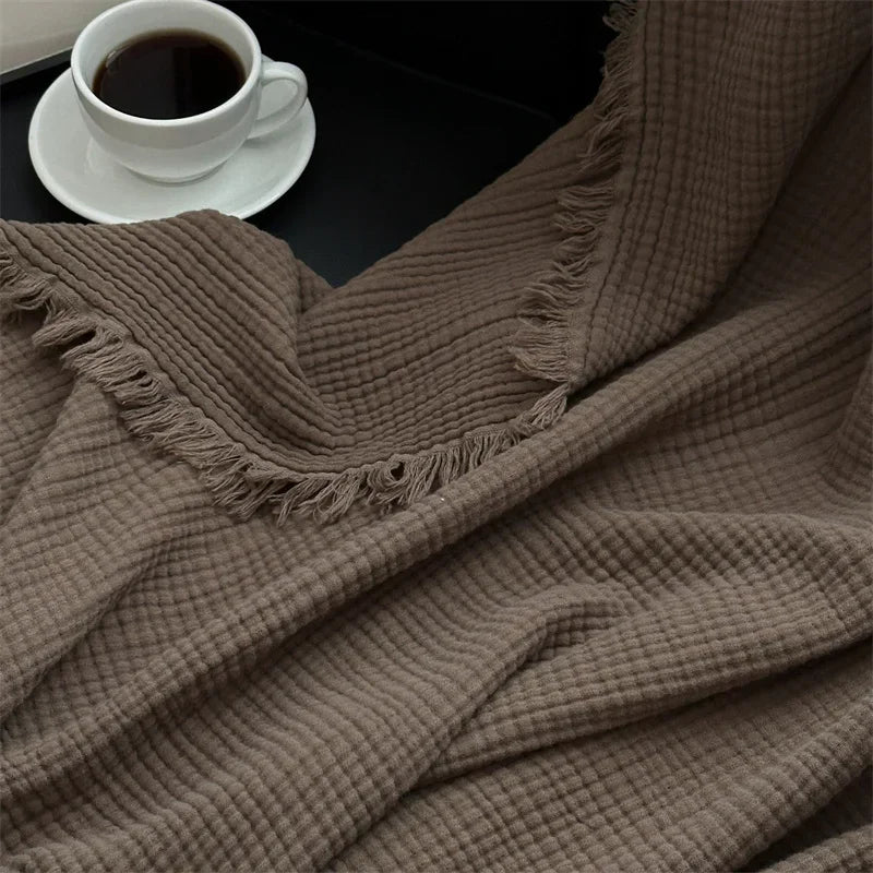1pc Blanket 100% Cotton Sofa Towel Tassels Bed Linen Solid Color Shawl manta Skin-friendly Plaid Home Blankets draped on a sofa.