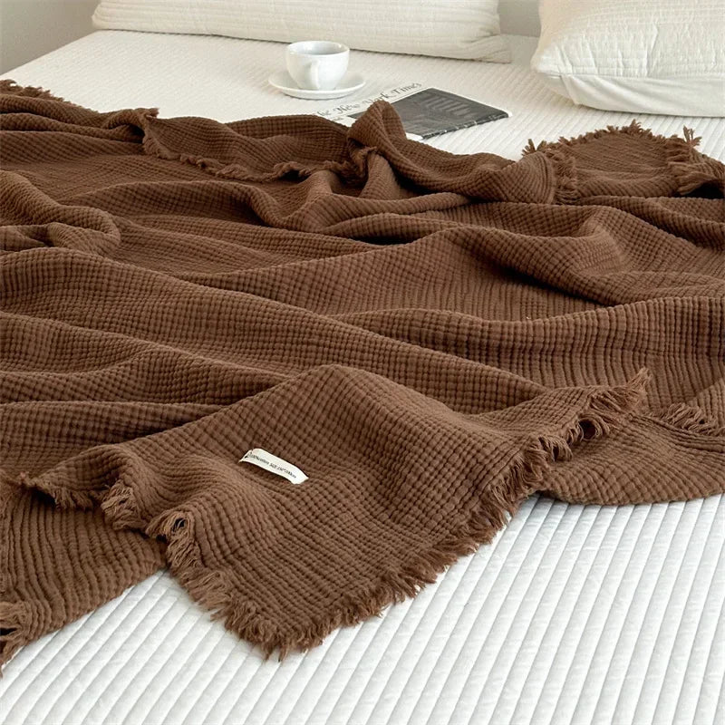 1pc Blanket 100% Cotton Sofa Towel Tassels Bed Linen Solid Color Shawl manta Skin-friendly Plaid Home Blankets draped on a sofa.