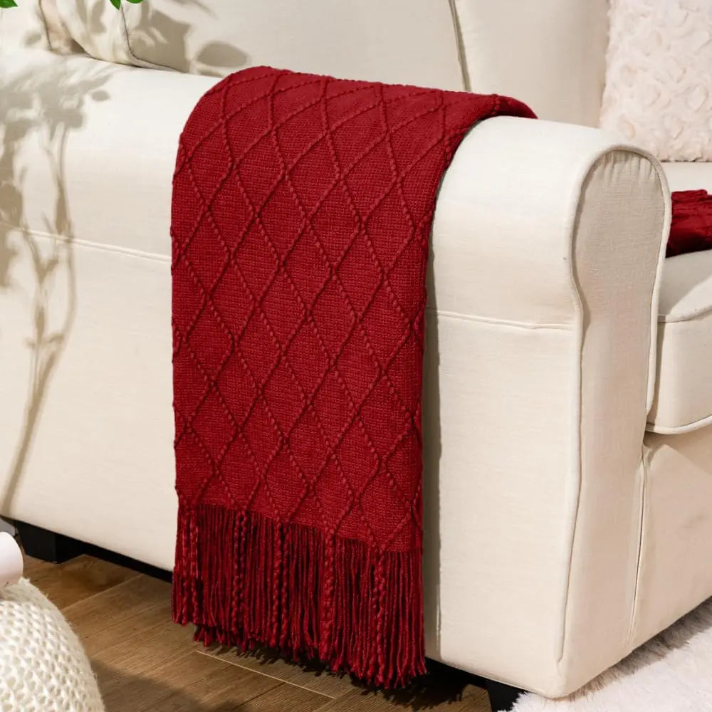 Battilo Plaid Knitted Throw Blanket Soft Woven Throws Sofa Blanket draped over a sofa arm.