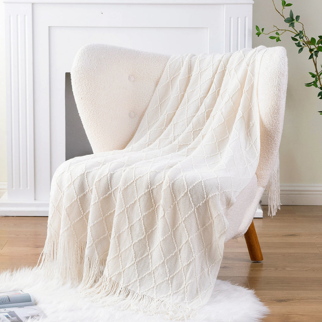 Battilo Plaid Knitted Throw Blanket Soft Woven Throws Sofa Blanket draped over a sofa arm.