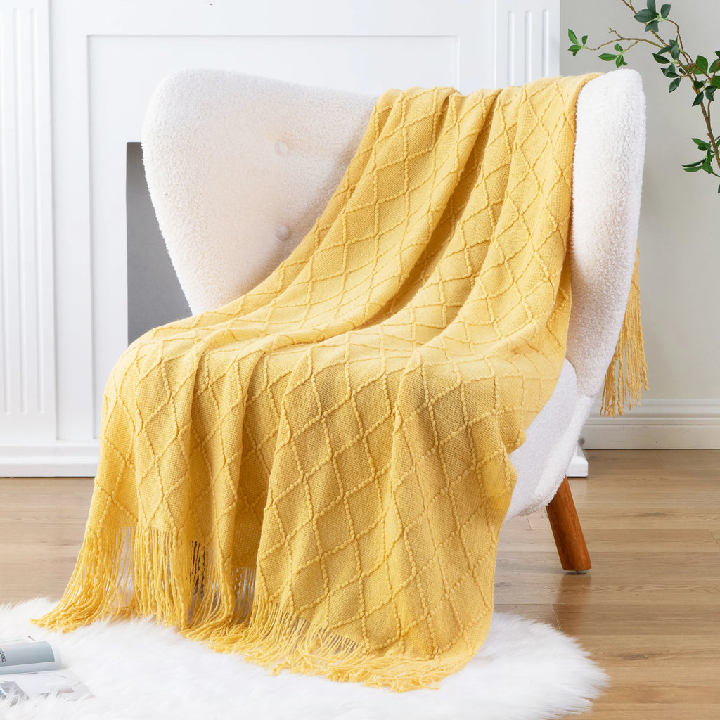 Battilo Plaid Knitted Throw Blanket Soft Woven Throws Sofa Blanket draped over a sofa arm.