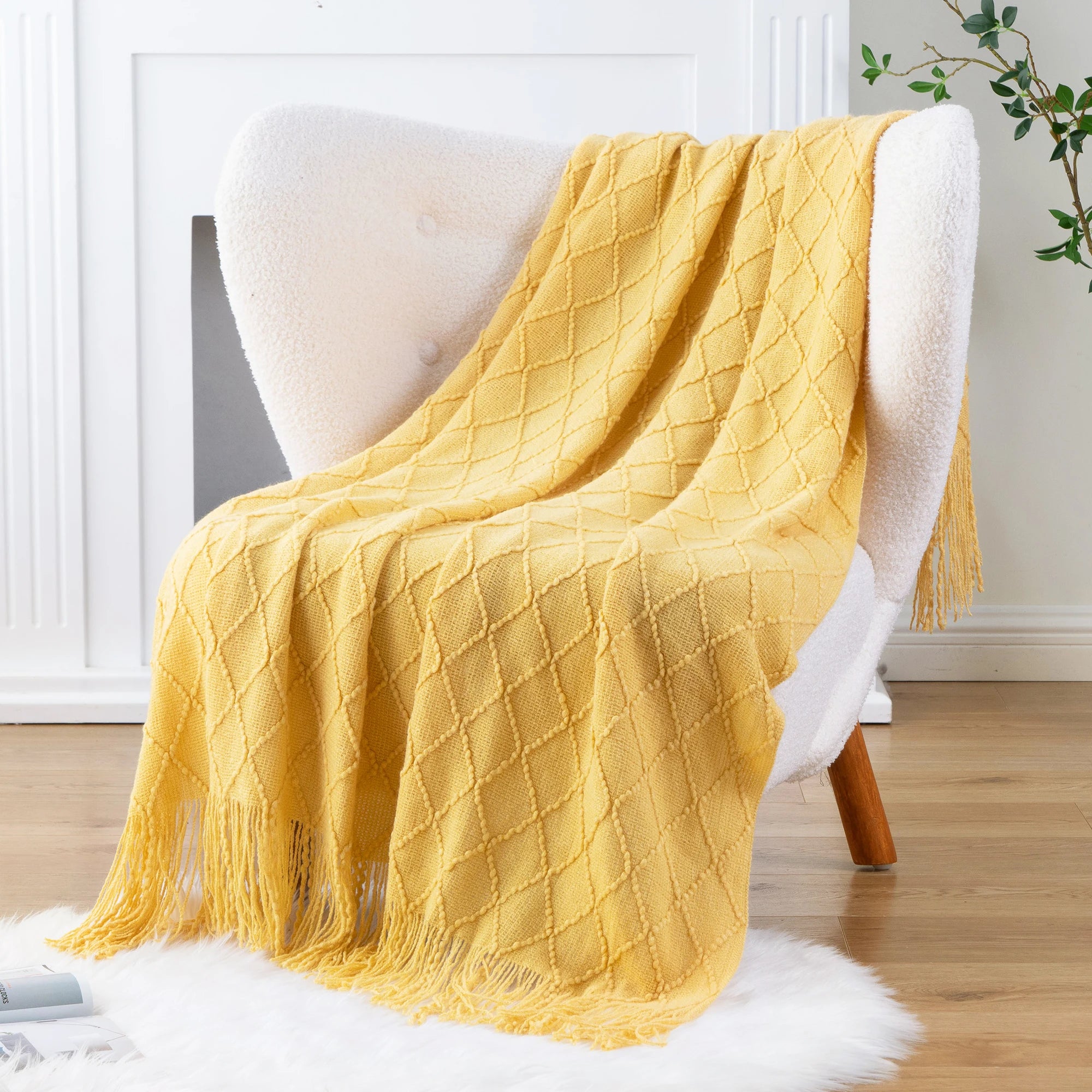 Battilo Plaid Knitted Throw Blanket Soft Woven Throws Sofa Blanket draped over a sofa arm.