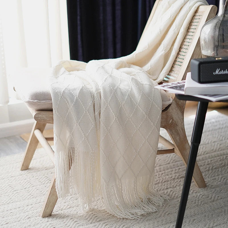Battilo Plaid Knitted Throw Blanket Soft Woven Throws Sofa Blanket draped over a sofa arm.