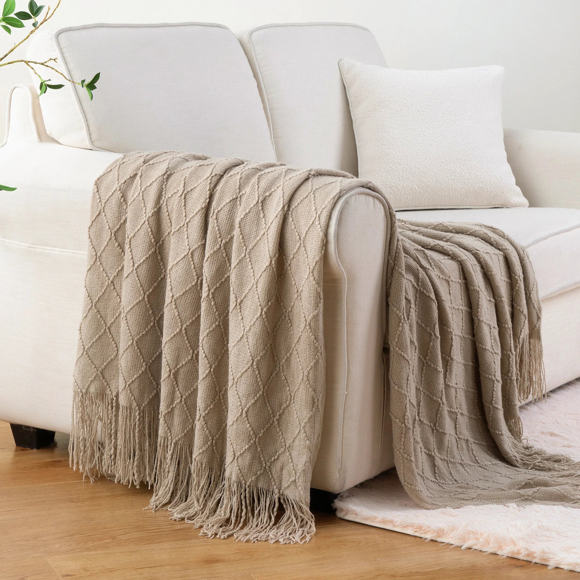Battilo Plaid Knitted Throw Blanket Soft Woven Throws Sofa Blanket draped over a sofa arm.