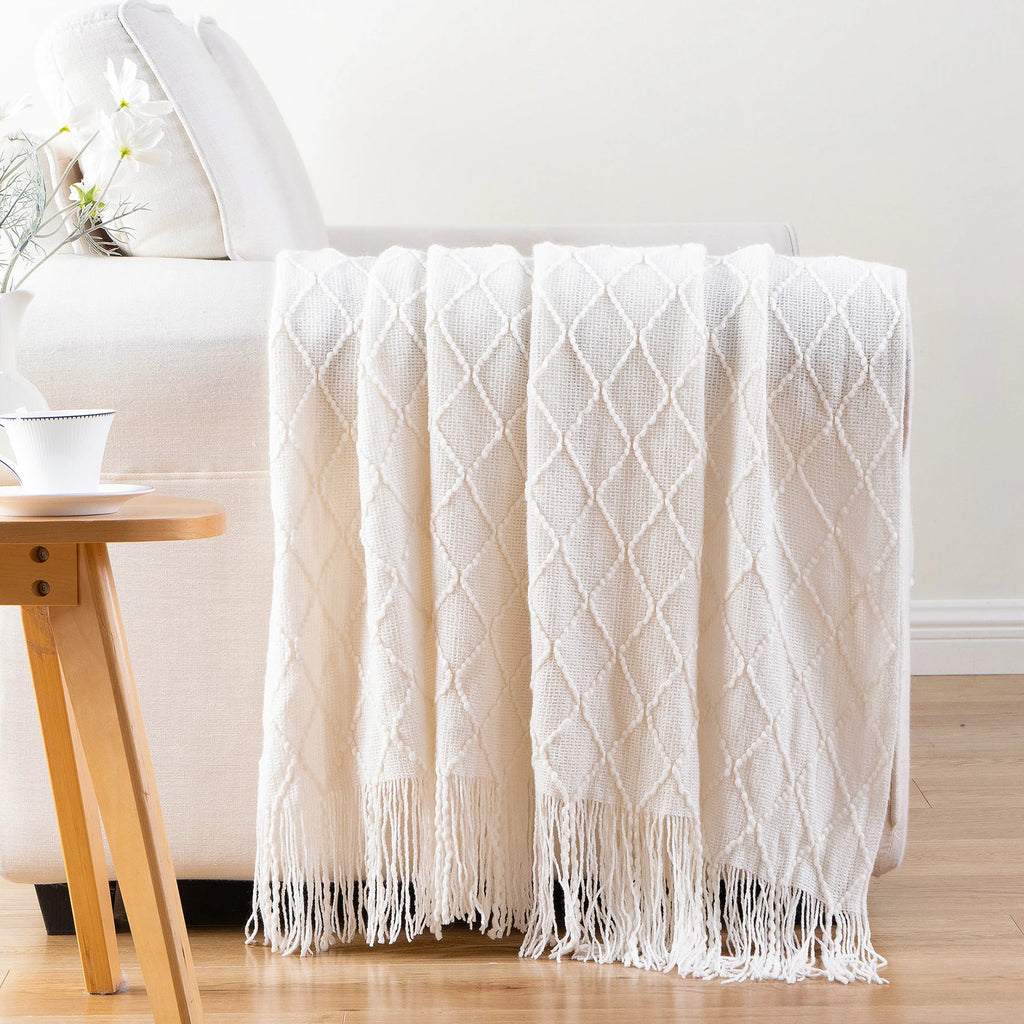 Battilo Plaid Knitted Throw Blanket Soft Woven Throws Sofa Blanket draped over a sofa arm.