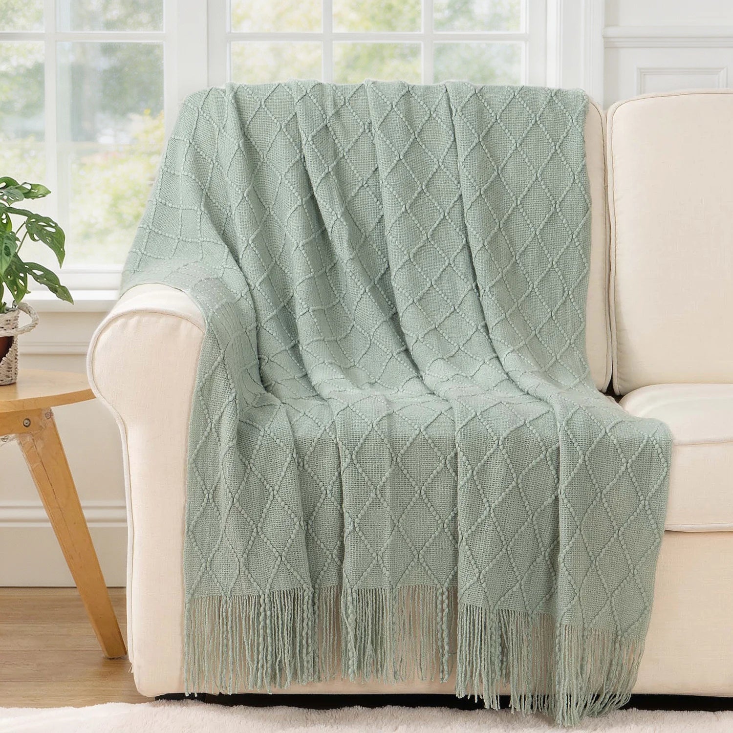 Battilo Plaid Knitted Throw Blanket Soft Woven Throws Sofa Blanket draped over a sofa arm.