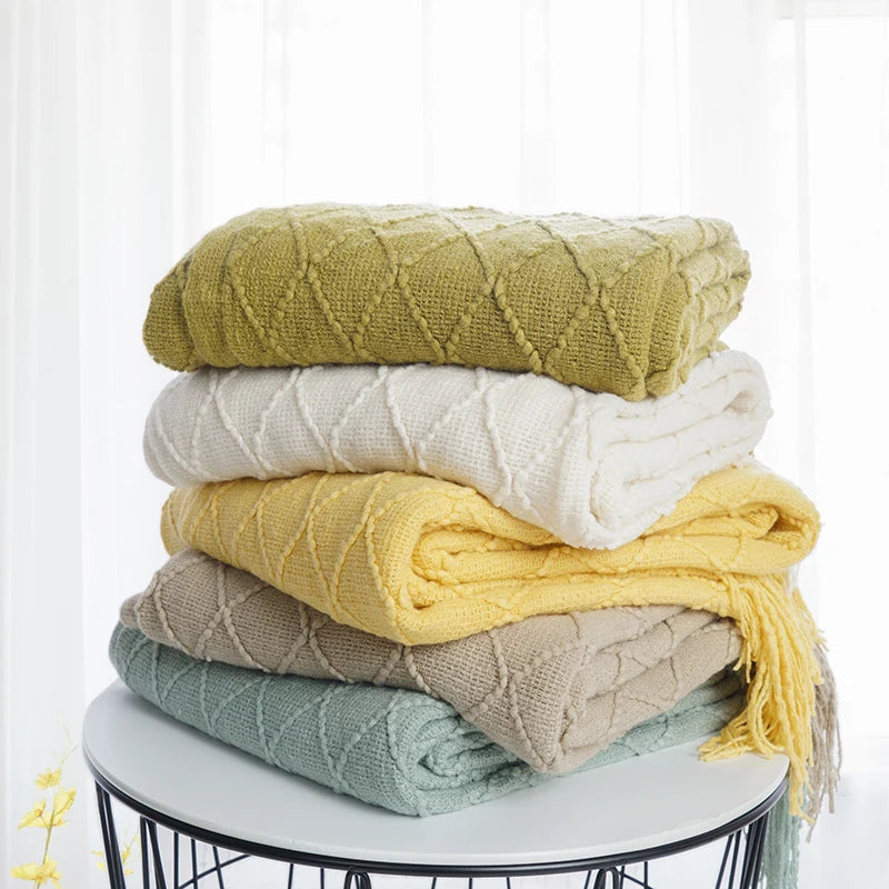 Battilo Plaid Knitted Throw Blanket Soft Woven Throws Sofa Blanket draped over a sofa arm.