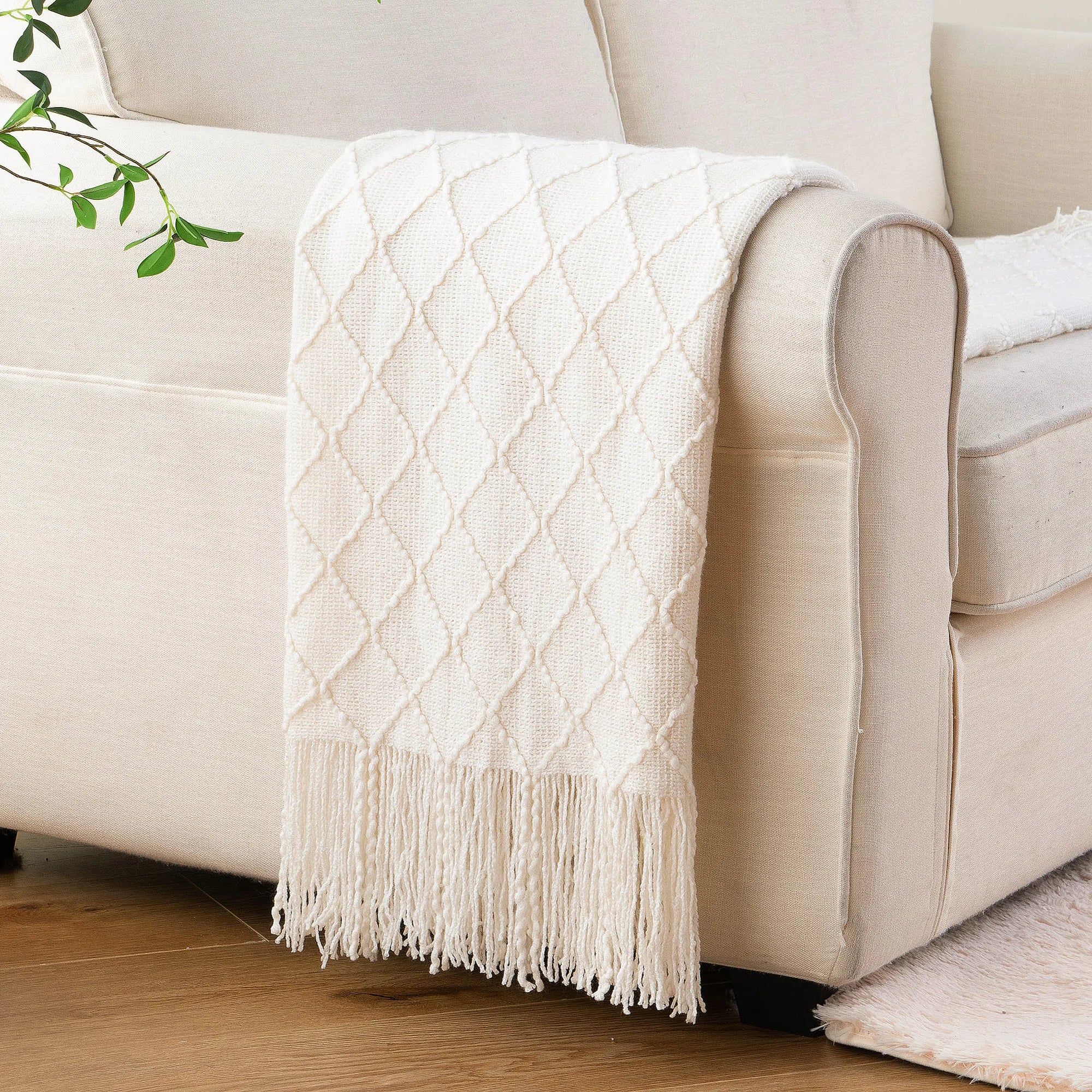 Battilo Plaid Knitted Throw Blanket Soft Woven Throws Sofa Blanket draped over a sofa arm.