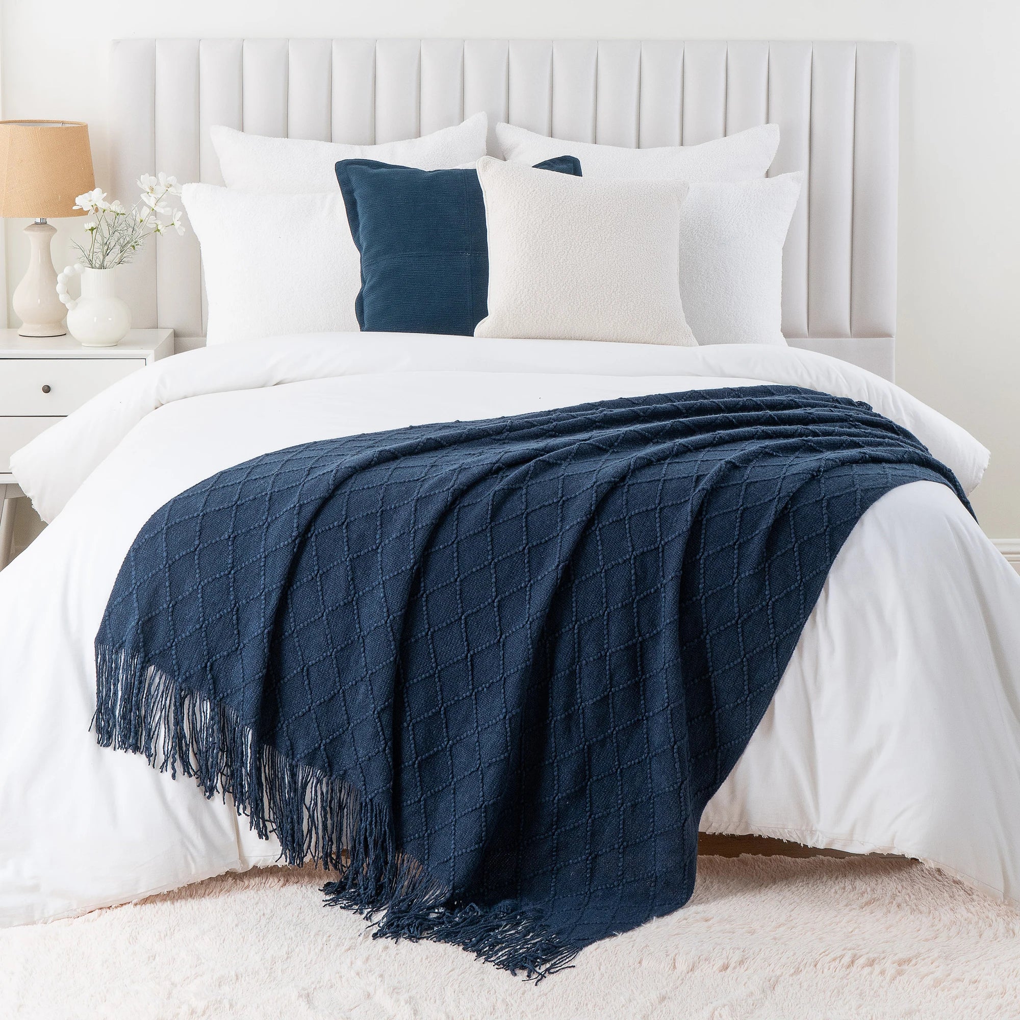 Battilo Plaid Knitted Throw Blanket Soft Woven Throws Sofa Blanket draped over a sofa arm.