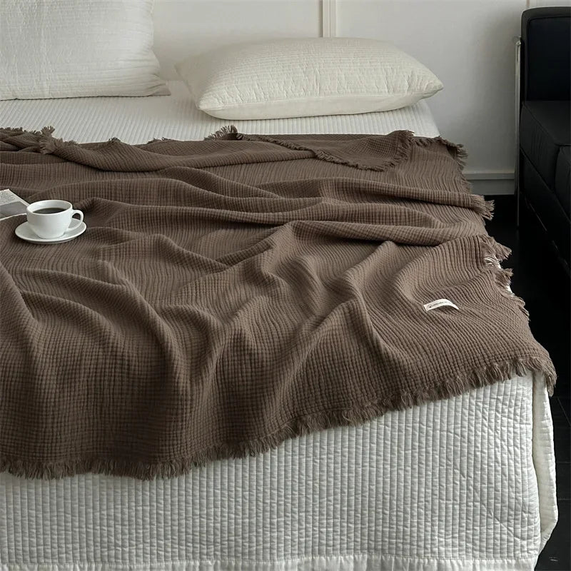 1pc Blanket 100% Cotton Sofa Towel Tassels Bed Linen Solid Color Shawl manta Skin-friendly Plaid Home Blankets draped on a sofa.