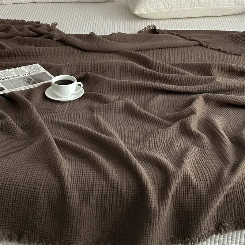 1pc Blanket 100% Cotton Sofa Towel Tassels Bed Linen Solid Color Shawl manta Skin-friendly Plaid Home Blankets draped on a sofa.