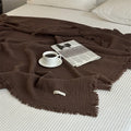 1pc Blanket 100% Cotton Sofa Towel Tassels Bed Linen Solid Color Shawl manta Skin-friendly Plaid Home Blankets draped on a sofa.