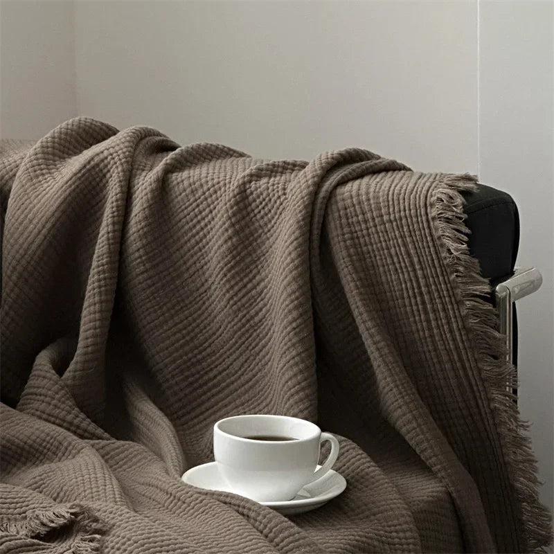 1pc Blanket 100% Cotton Sofa Towel Tassels Bed Linen Solid Color Shawl manta Skin-friendly Plaid Home Blankets draped on a sofa.