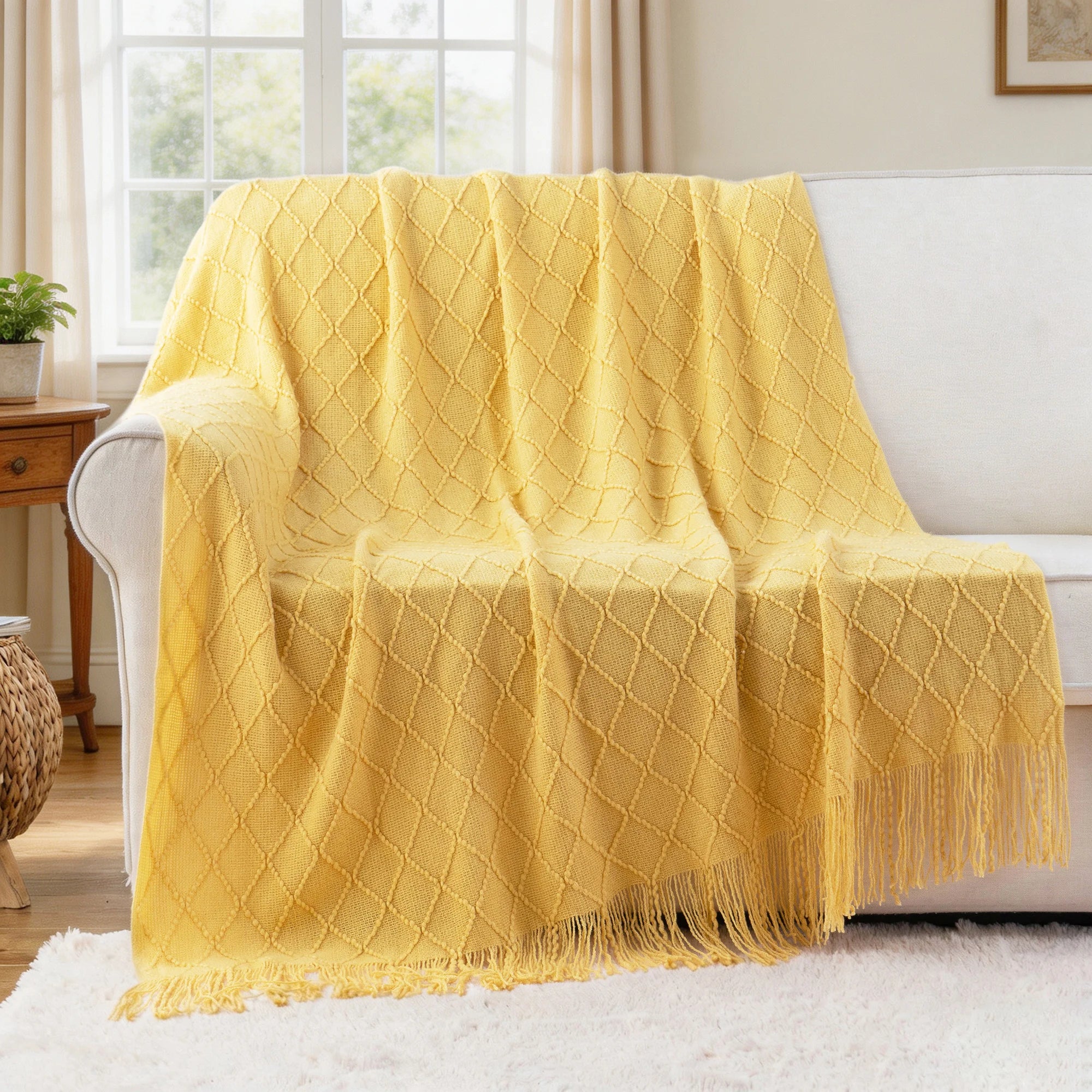 Battilo Plaid Knitted Throw Blanket Soft Woven Throws Sofa Blanket draped over a sofa arm.