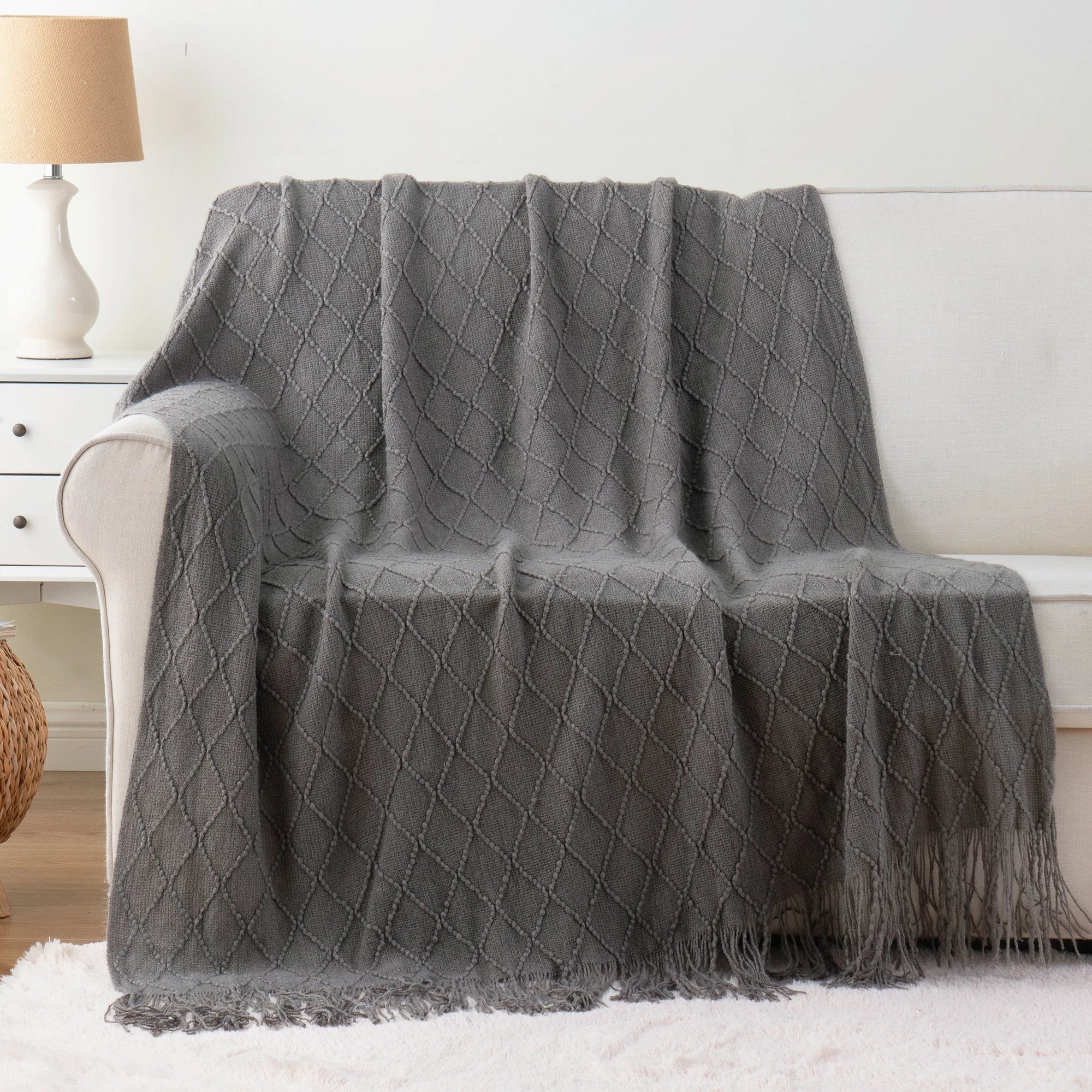Battilo Plaid Knitted Throw Blanket Soft Woven Throws Sofa Blanket draped over a sofa arm.
