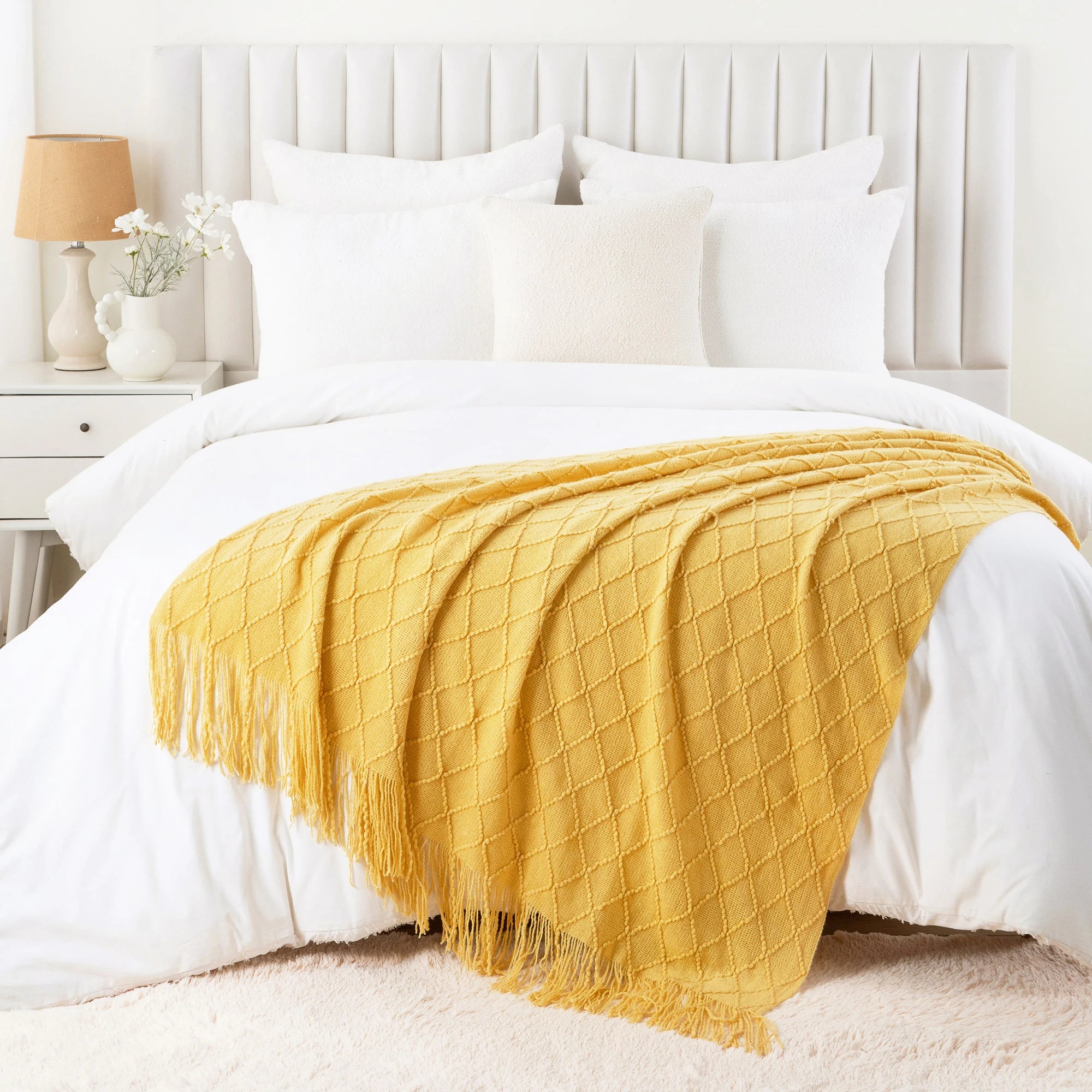 Battilo Plaid Knitted Throw Blanket Soft Woven Throws Sofa Blanket draped over a sofa arm.