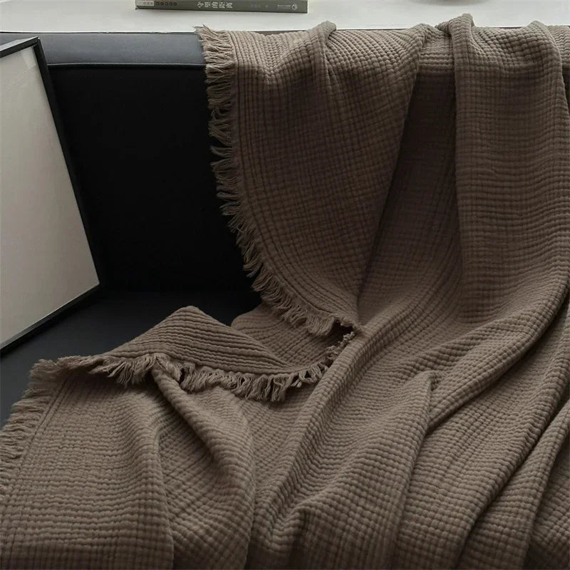 1pc Blanket 100% Cotton Sofa Towel Tassels Bed Linen Solid Color Shawl manta Skin-friendly Plaid Home Blankets draped on a sofa.