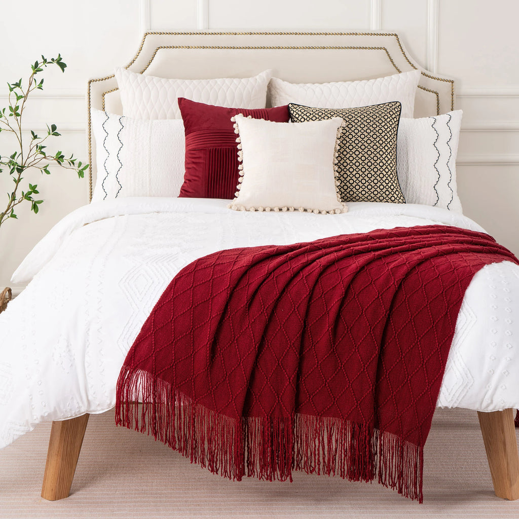 Battilo Plaid Knitted Throw Blanket Soft Woven Throws Sofa Blanket draped over a sofa arm.