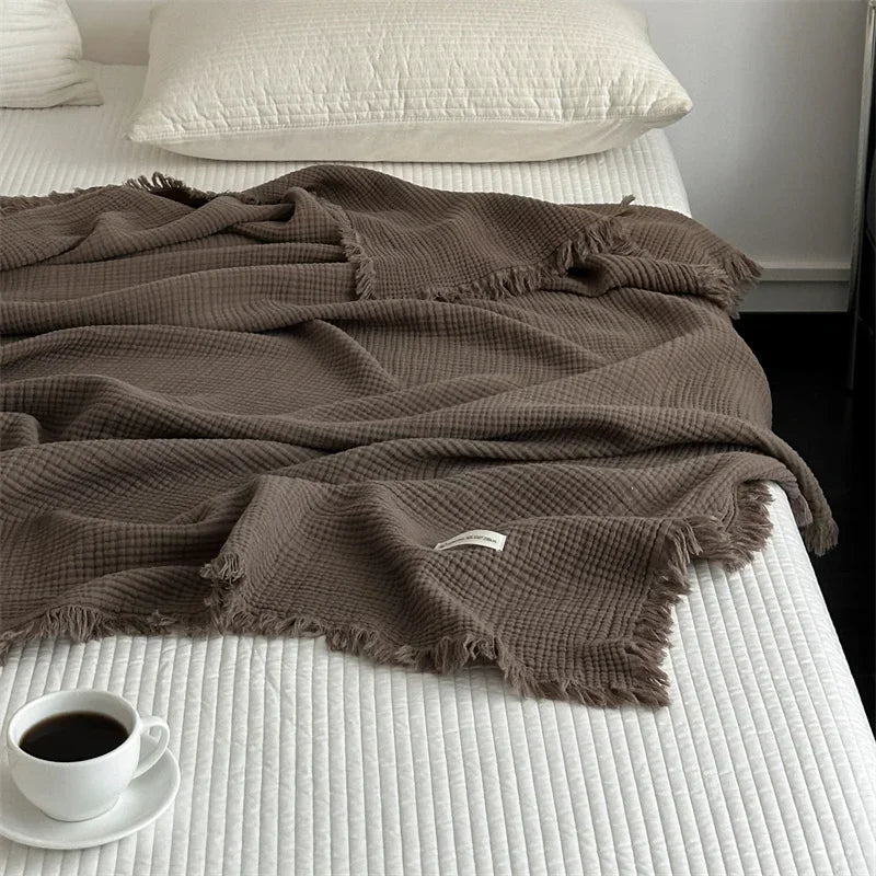 1pc Blanket 100% Cotton Sofa Towel Tassels Bed Linen Solid Color Shawl manta Skin-friendly Plaid Home Blankets draped on a sofa.
