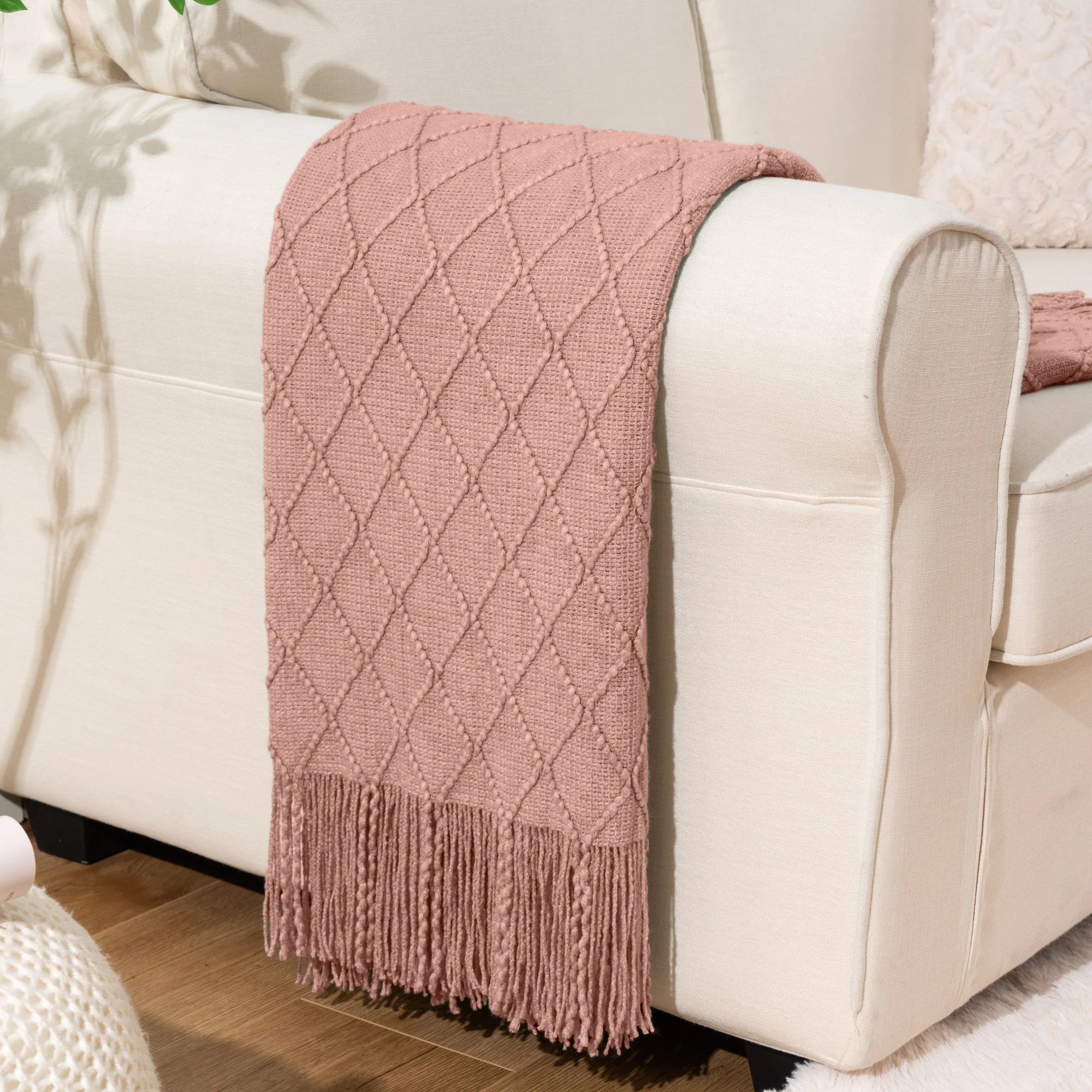 Battilo Plaid Knitted Throw Blanket Soft Woven Throws Sofa Blanket draped over a sofa arm.