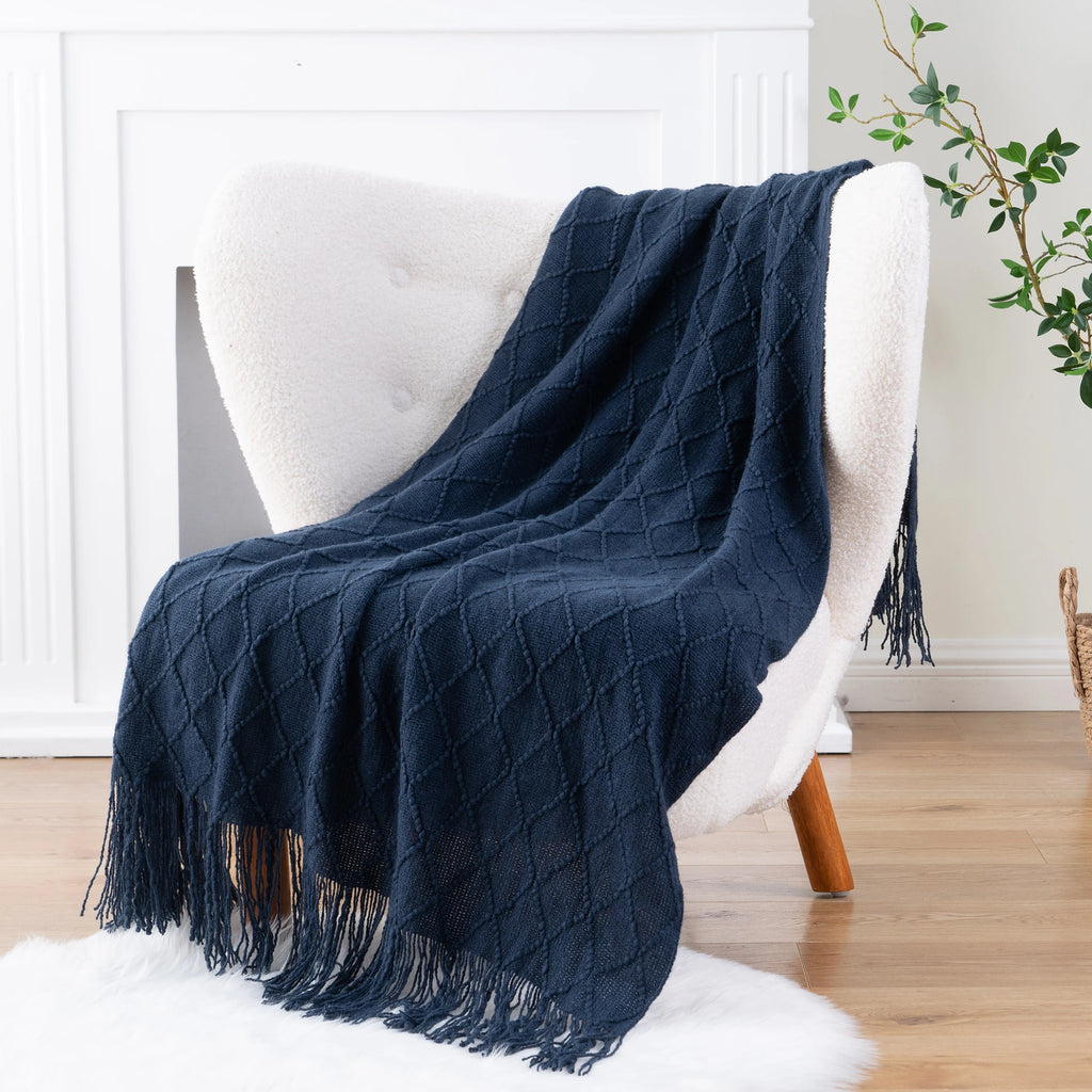 Battilo Plaid Knitted Throw Blanket Soft Woven Throws Sofa Blanket draped over a sofa arm.