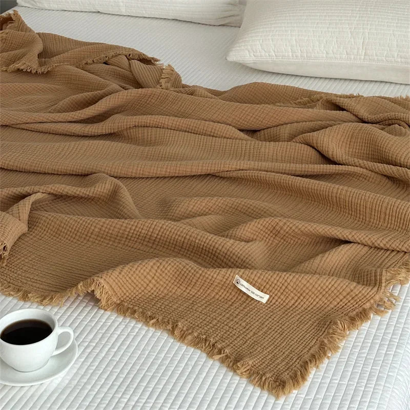 1pc Blanket 100% Cotton Sofa Towel Tassels Bed Linen Solid Color Shawl manta Skin-friendly Plaid Home Blankets draped on a sofa.