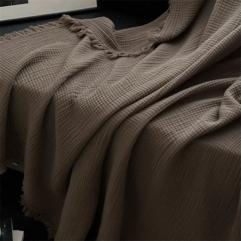 1pc Blanket 100% Cotton Sofa Towel Tassels Bed Linen Solid Color Shawl manta Skin-friendly Plaid Home Blankets draped on a sofa.
