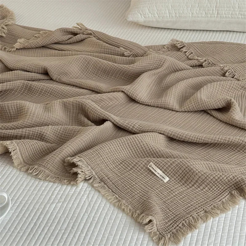 1pc Blanket 100% Cotton Sofa Towel Tassels Bed Linen Solid Color Shawl manta Skin-friendly Plaid Home Blankets draped on a sofa.